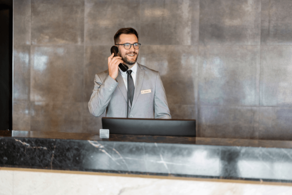Hotel front desk staff receiving phone call through PBX phone system.