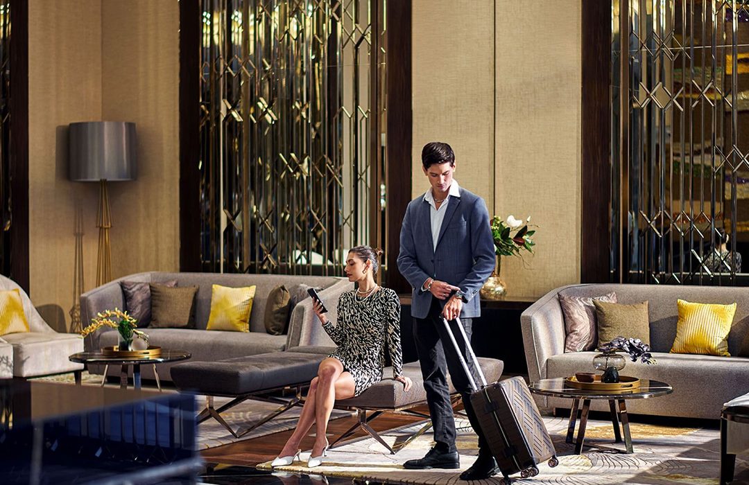 Guests relaxing in the lobby at Chatrium Grand Bangkok.